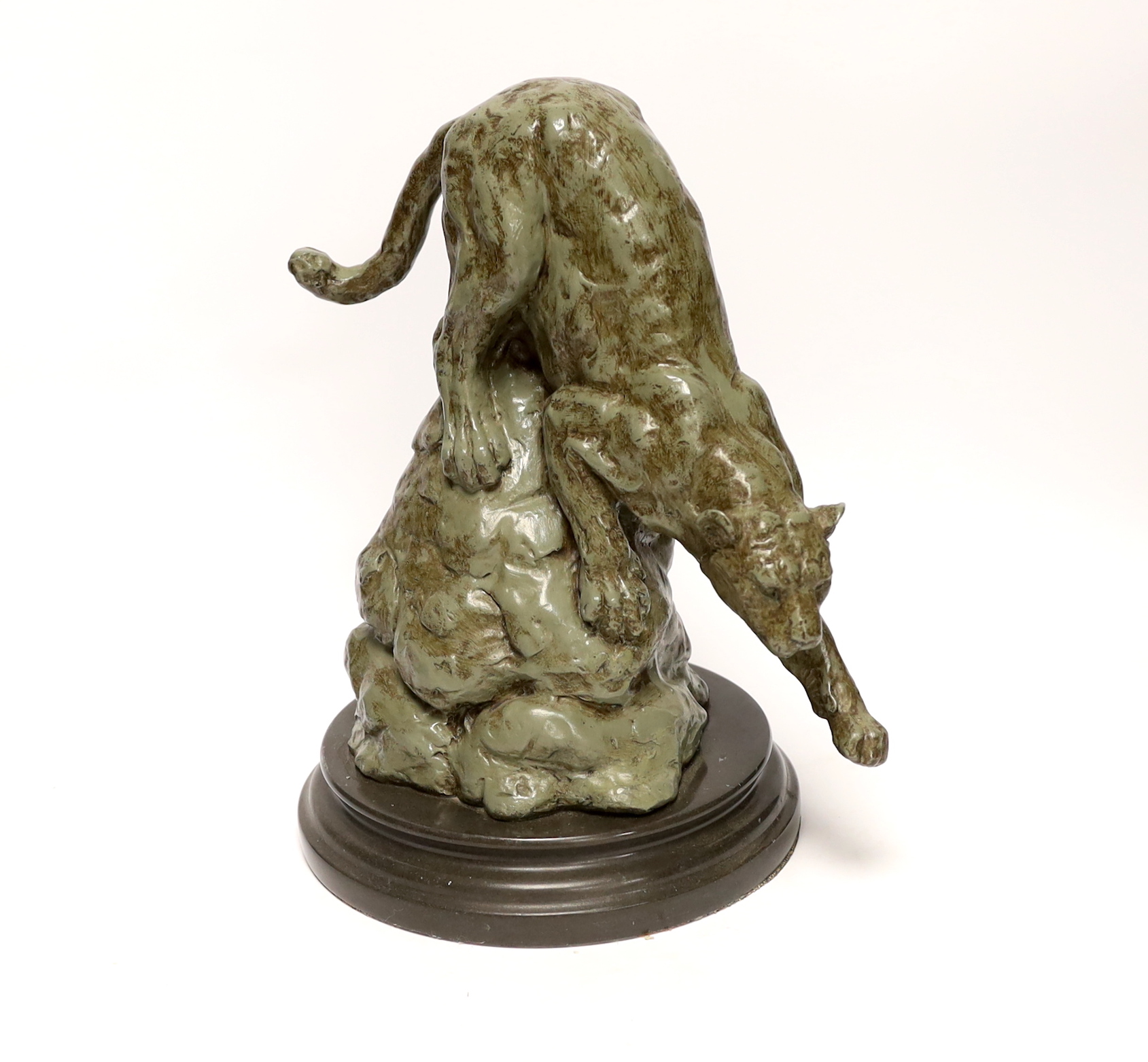 After Antoine Louis Barye, a patinated metal study of a leopard, raised on shaped circular base, 28cm high